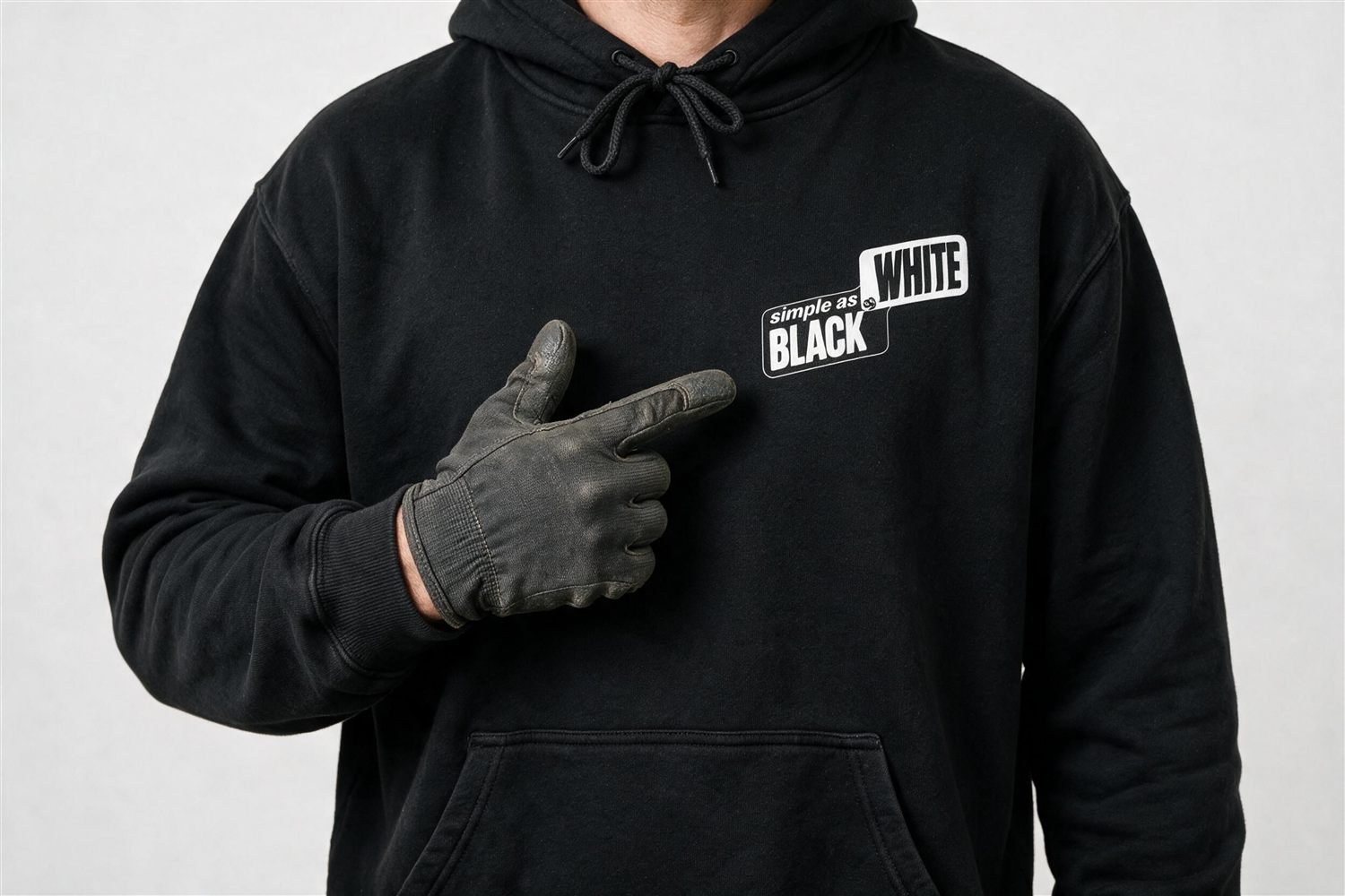 Close-up of the Simple as Black and White logo on a crew member's black hoodie