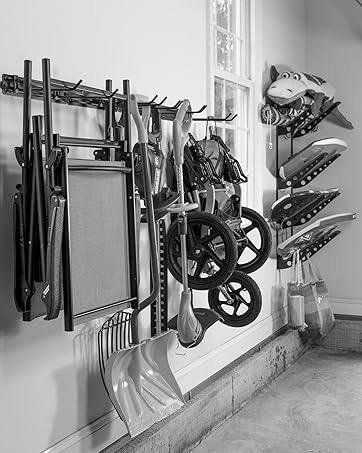 Folding chairs, shovels and a stroller hung on a garage wall rack